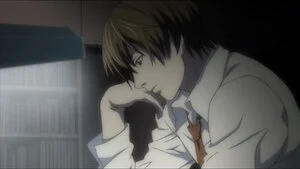 Light Yagami seated in the Death Note anime